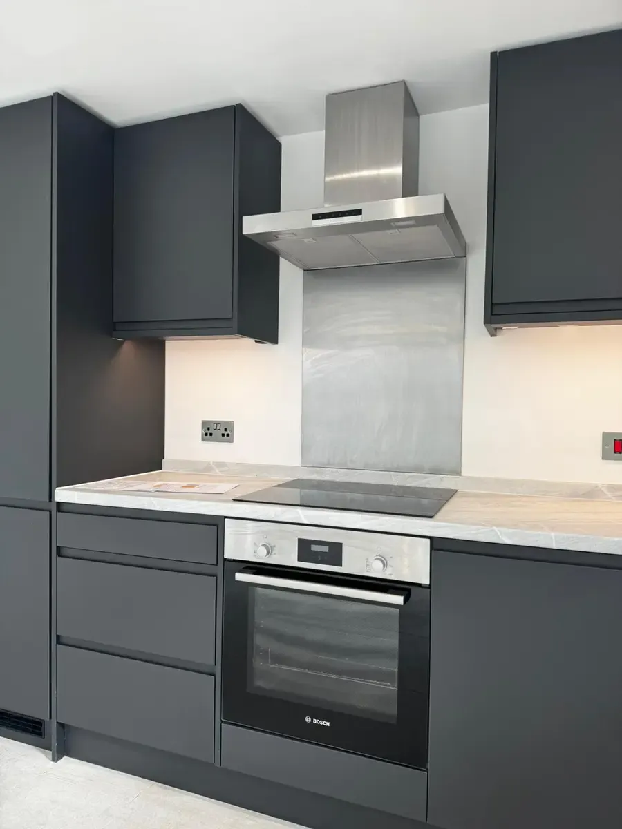 Modern kitchen with dark cabinets and premium appliances Norwich flats