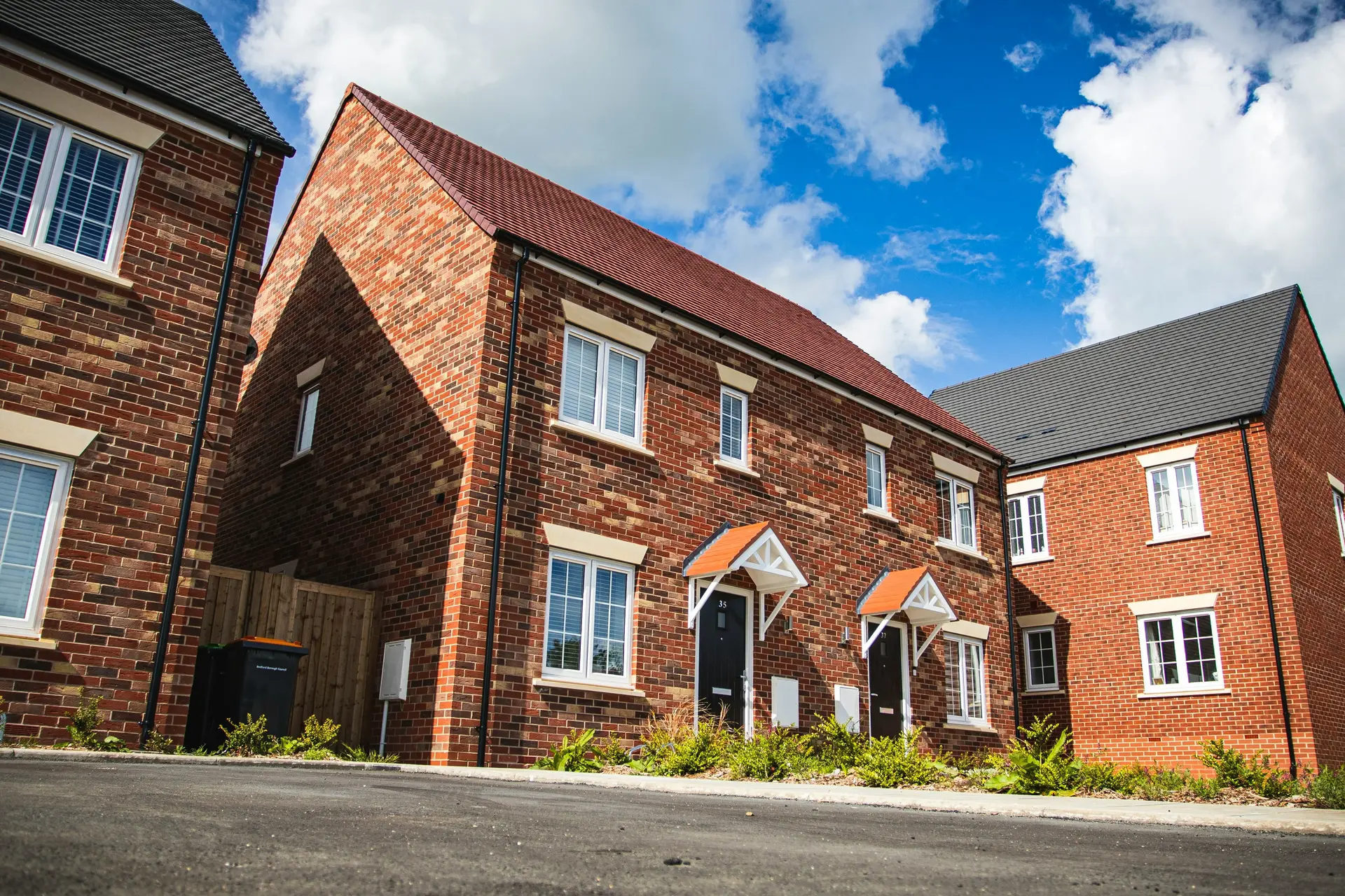 Exterior rear view of a newly constructed family home with patio area